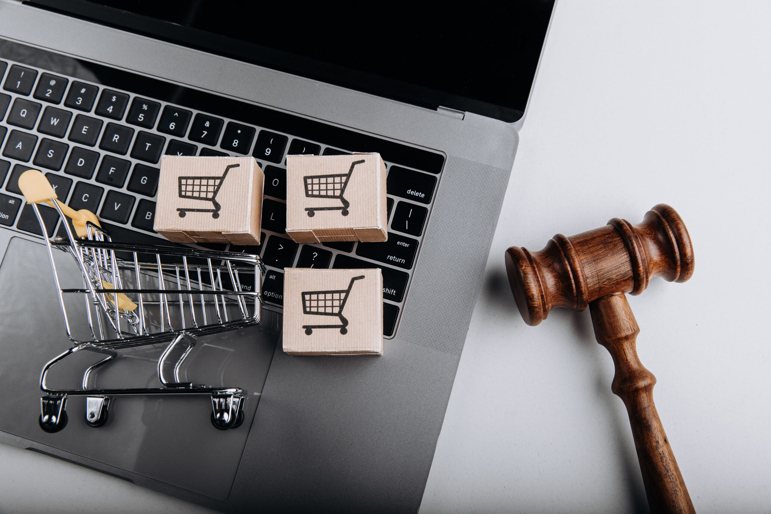 judge-gavel-shopping-cart-with-card-boxes-laptop-sanctions-concept-scaled.jpg